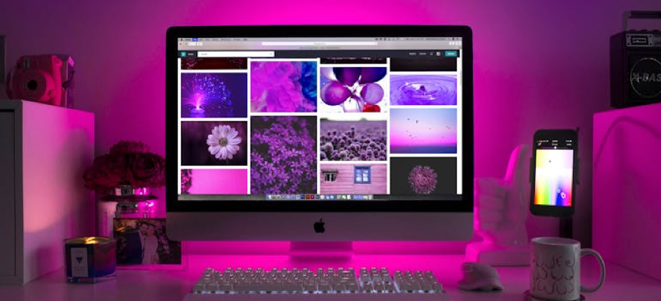 a computer with purple light around and matching images on the screen